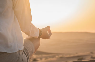 Woman meditating in desert