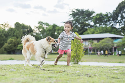 Portrait of woman with dogs on field