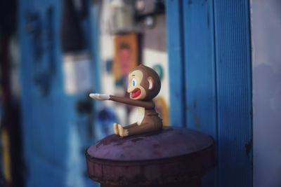 Close-up of monkey figurine on pole