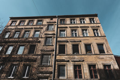 Low angle view of old building against blue sky