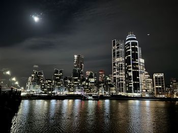 Illuminated city at waterfront