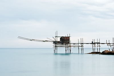 Lifeguard hut by sea against sky