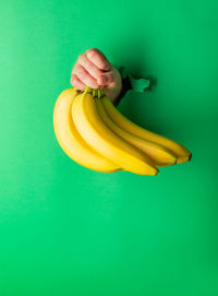 High angle view of yellow fruit against green background