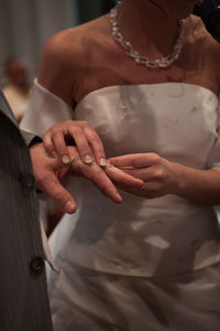 Midsection of couple holding hands