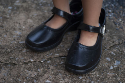 Selective focus of adult shoes worn by children, development of preschool children