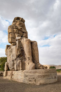 Low angle view of statue against cloudy sky
