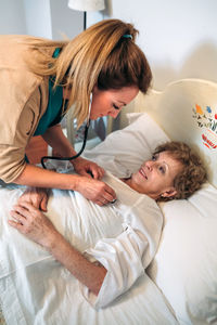 Young woman lying on bed