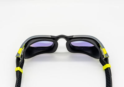 Close-up of sunglasses against white background