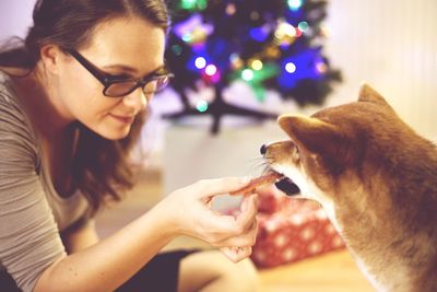 Side view of woman with dog at home