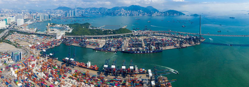 High angle view of cityscape by sea against sky