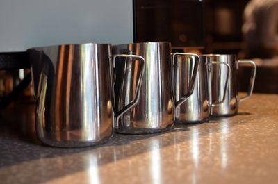 Close-up of coffee cups on table