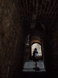 Full length of woman standing in tunnel