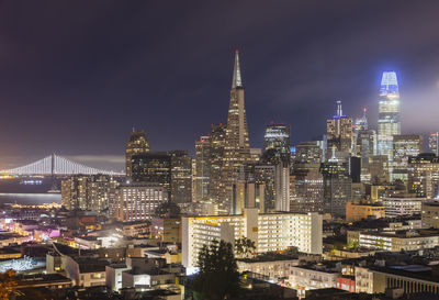 Illuminated buildings in city at night