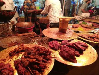 Midsection of people at market stall