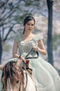 At sunset, a beautiful sensual girl and her horse go through the woods. horses are adored by girls.