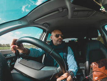 Man sitting in car