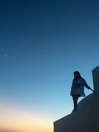 Low angle view of silhouette woman against clear sky in greece