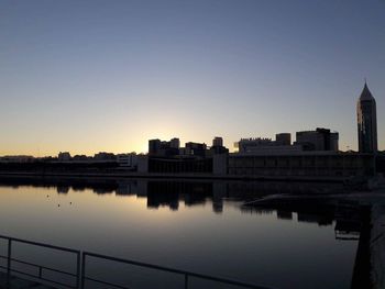 Reflection of buildings in city at waterfront