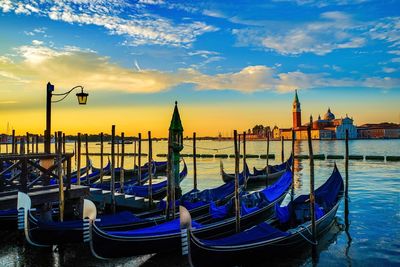 Boats moored in sea against blue sky