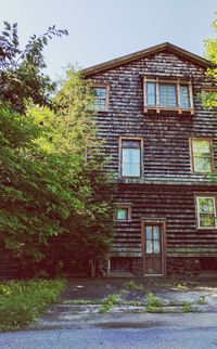 House by trees against sky