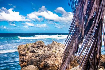 Panoramic shot of rocks on beach against sky