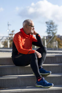 Full length of senior man sitting on steps