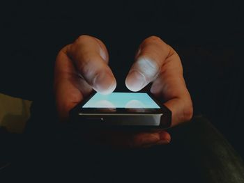 Cropped hands of person using mobile phone