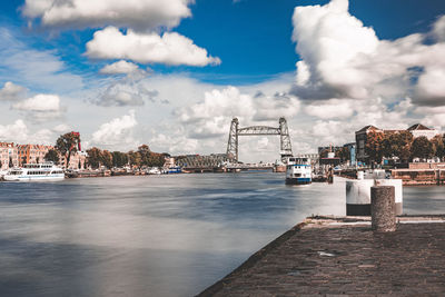 Pier by sea against sky in city