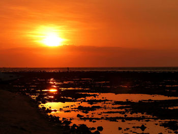 Scenic view of sea against romantic sky at sunset