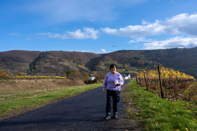 Full length of man standing on road against sky