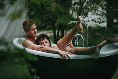 Couple in bathtub outdoors