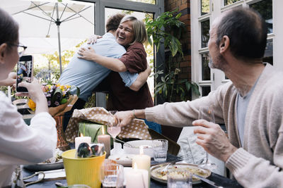 Happy parent embracing son during party at restaurant