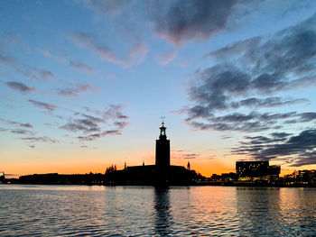 Silhouette of building against cloudy sky during sunset