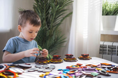 Portrait of cute girl playing with toys at home