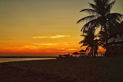 Scenic view of beach against sky during sunset