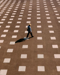 High angle view of woman on tiled floor