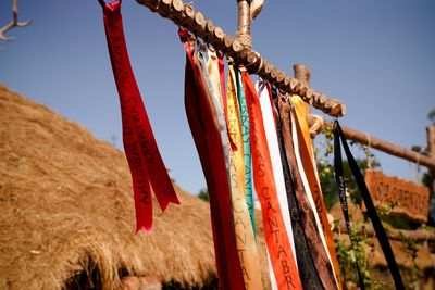 Low angle view of clothes drying on rope against sky