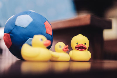 Still life of three yellow ducklings and a blue soft ball