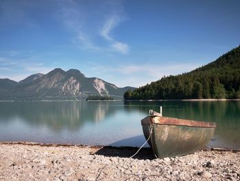 Pebbles shore of beautiful german mountain lake in remote wilderness.