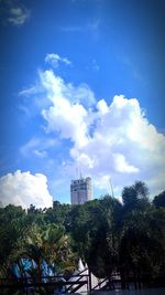 Low angle view of building against cloudy sky