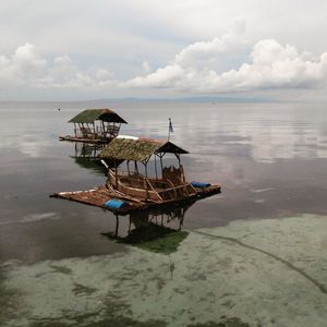 Lifeguard hut in sea against sky