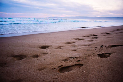 Footsteps in the sand.