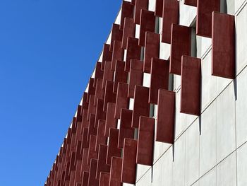 Low angle view of modern buildings against clear blue sky