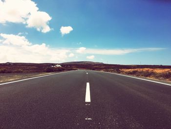 Empty road leading towards mountain