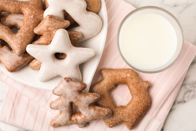 Cropped hand holding cookies on table