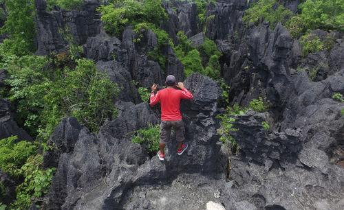 Rear view of man on rock formation