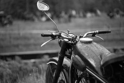Close-up of bicycle parked against blurred background