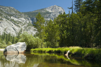 Scenic view of lake by trees against mountain at yosemite national park