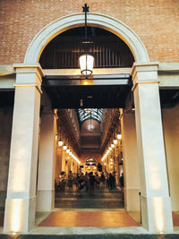 People walking in illuminated building