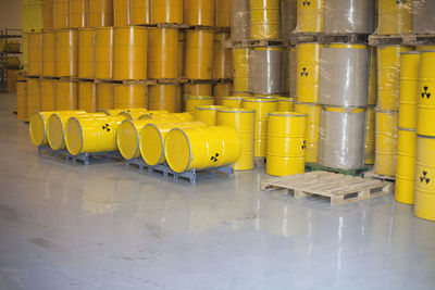 Hazard signs on yellow barrels in industry